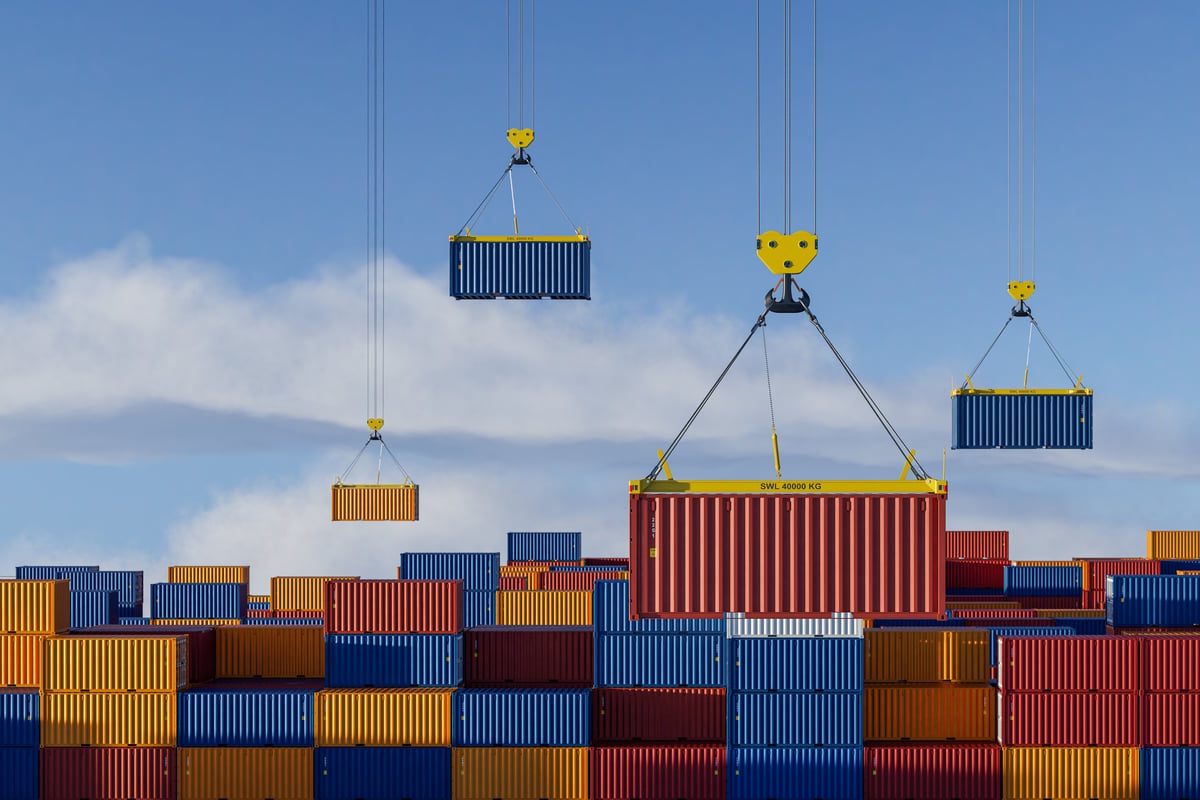 Cranes operating in a busy container port and freight yard